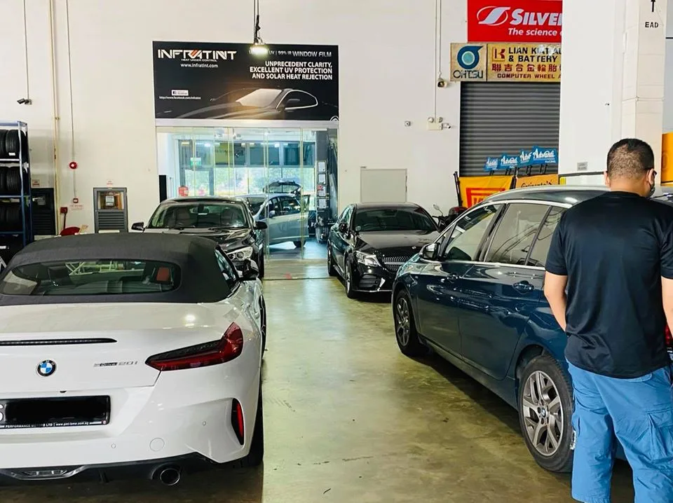 White BMW Z4 and blue BMW 3 Series Touring at Infratint Singapore for window tinting