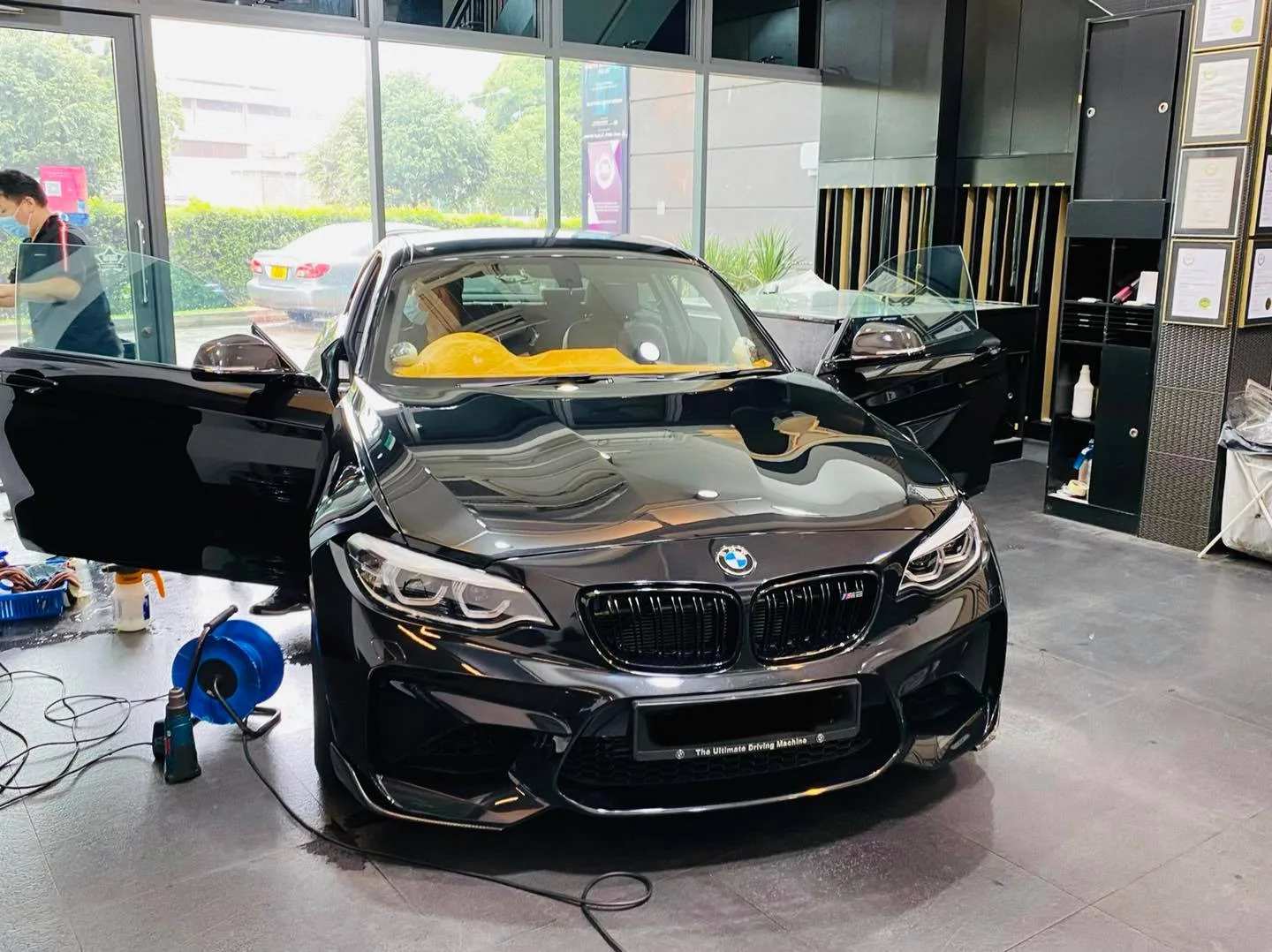 Black BMW 2 Series coupe with doors open at Infratint Singapore for window tinting