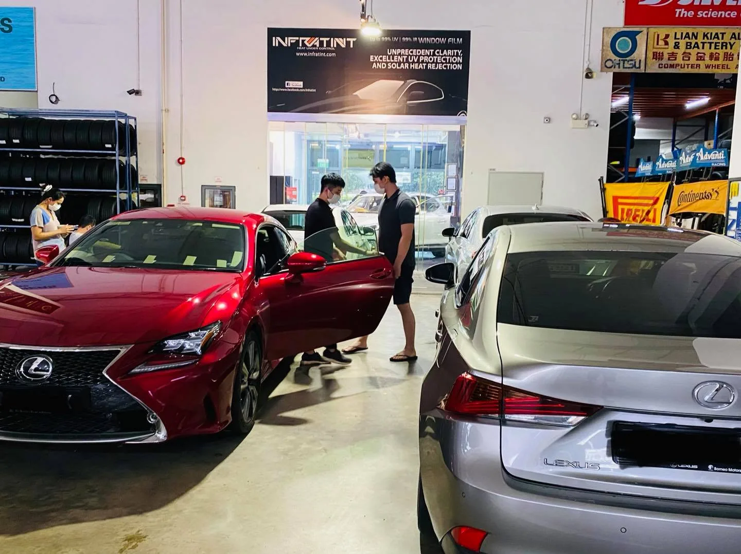 Red Lexus RC coupe and silver Lexus sedan in the workshop at Infratint Singapore