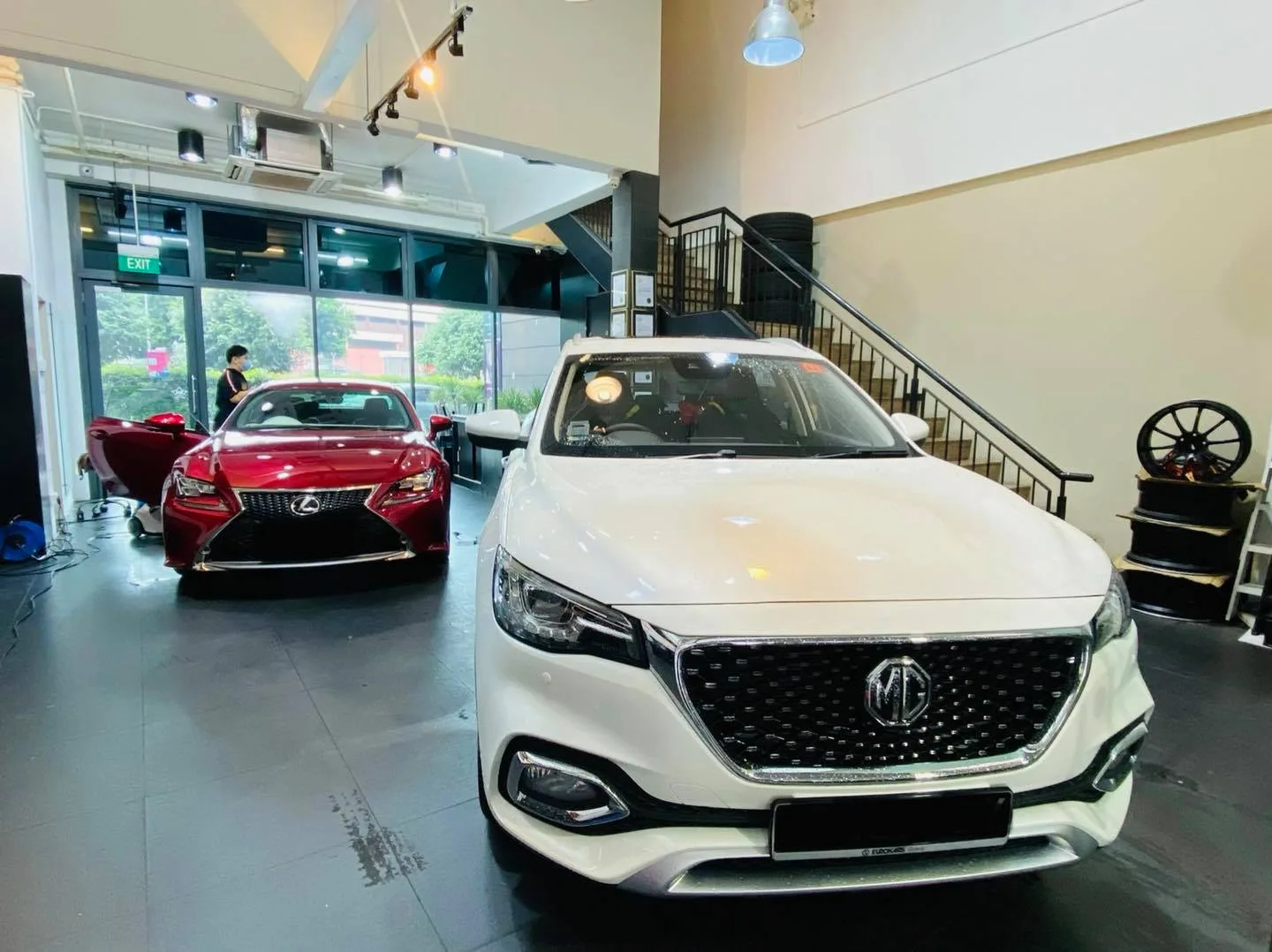White MG HS and red Lexus RC coupe inside Infratint Singapore for window tinting