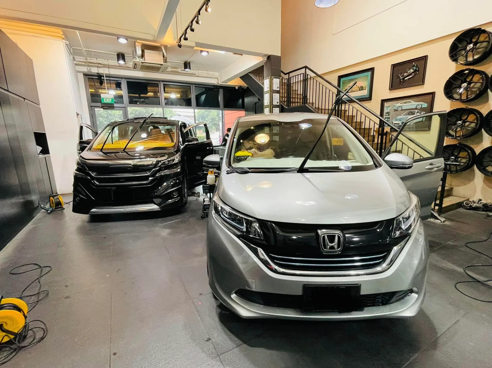 Silver Honda Freed beside a black Toyota Alphard at Infratint Singapore