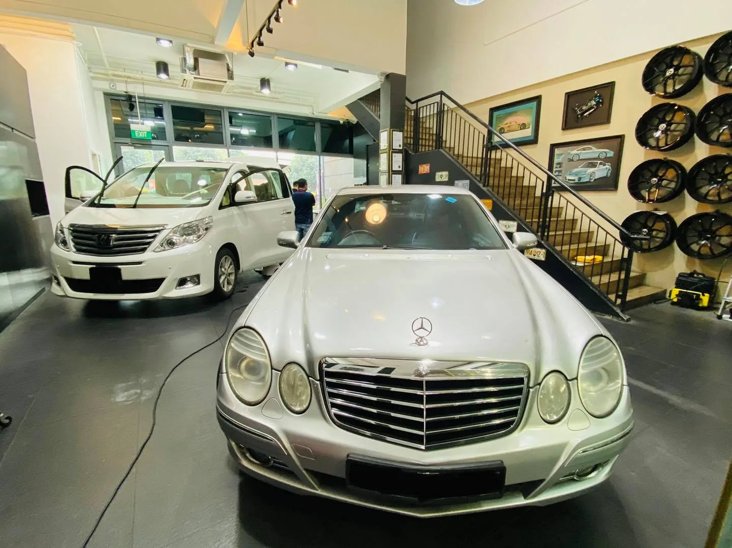 Silver Mercedes-Benz E-Class sedan at Infratint Singapore with a Toyota Alphard behind