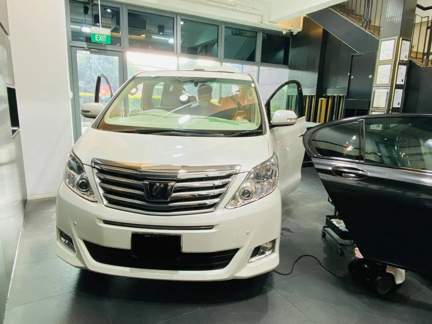 White Toyota Alphard with doors open during window film install at Infratint Singapore