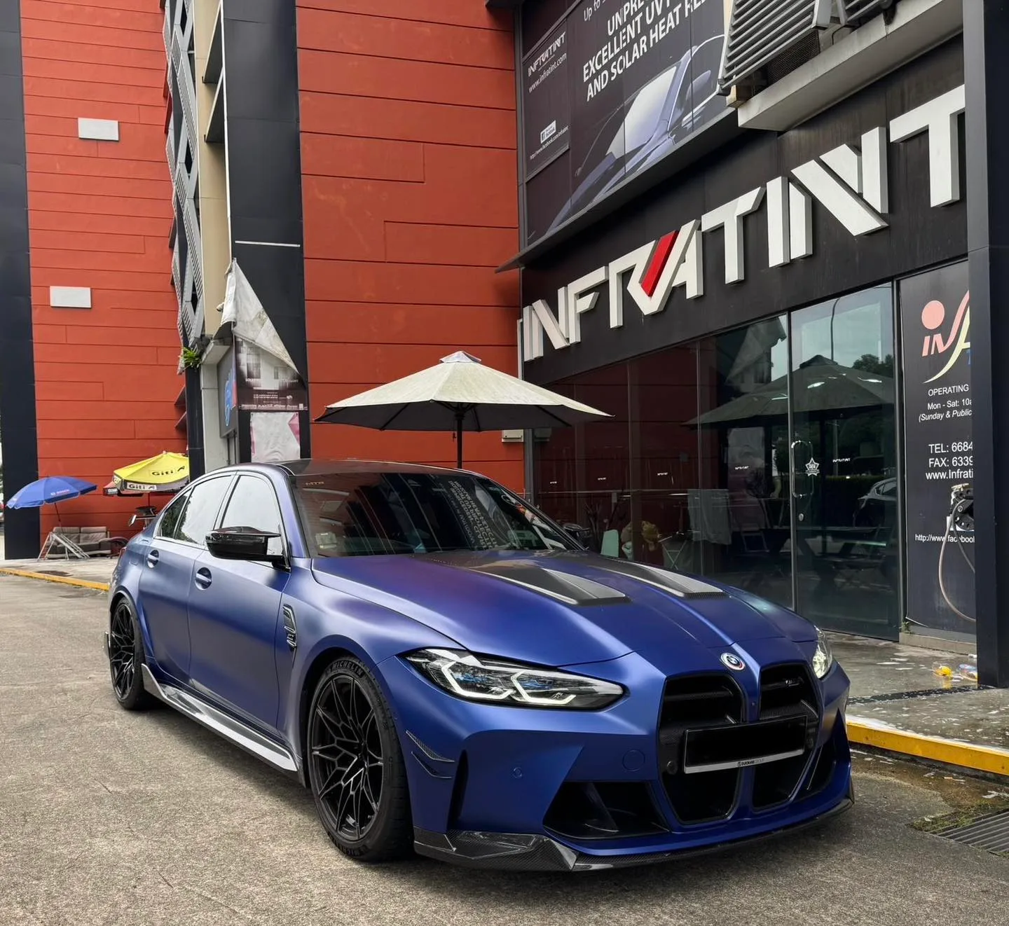 Matte blue BMW M3 front three-quarter view with tinted glass at Infratint Singapore