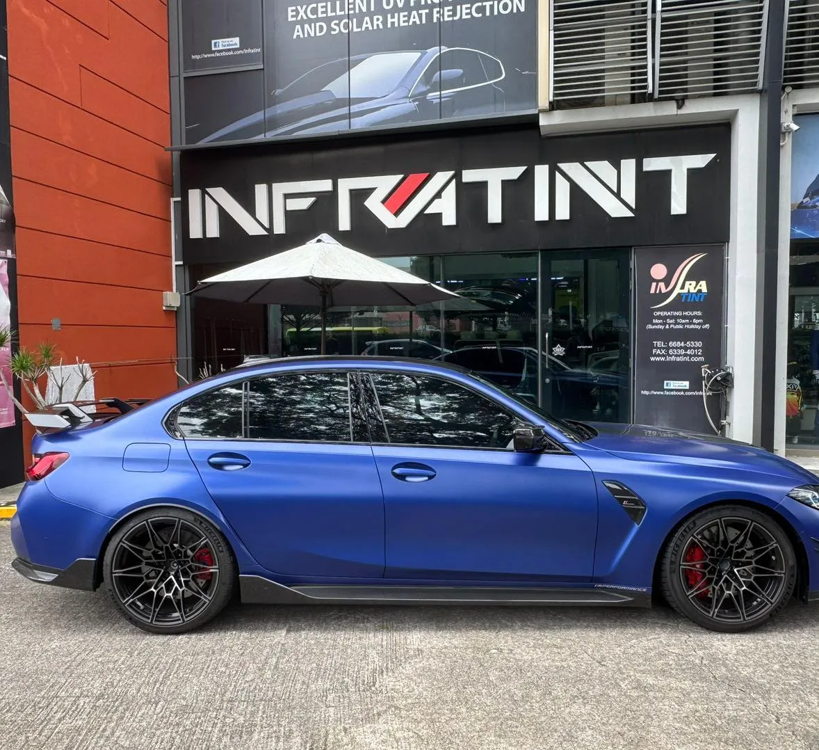 Matte blue BMW M3 side profile with tinted glass outside Infratint Singapore