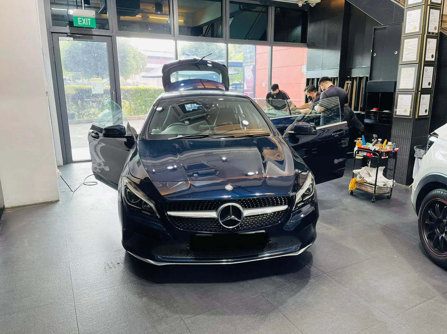 Dark blue Mercedes-Benz CLA with boot open during window tinting at Infratint Singapore