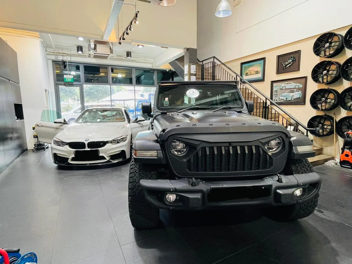 Grey Jeep Wrangler and a white BMW M sedan inside Infratint Singapore