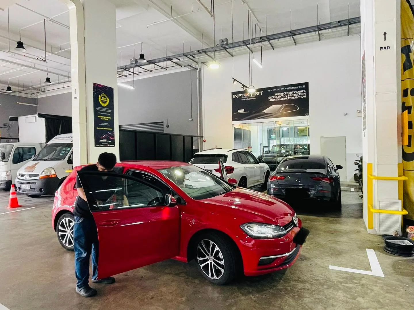 Red Volkswagen Golf being prepped for window tinting at Infratint Singapore
