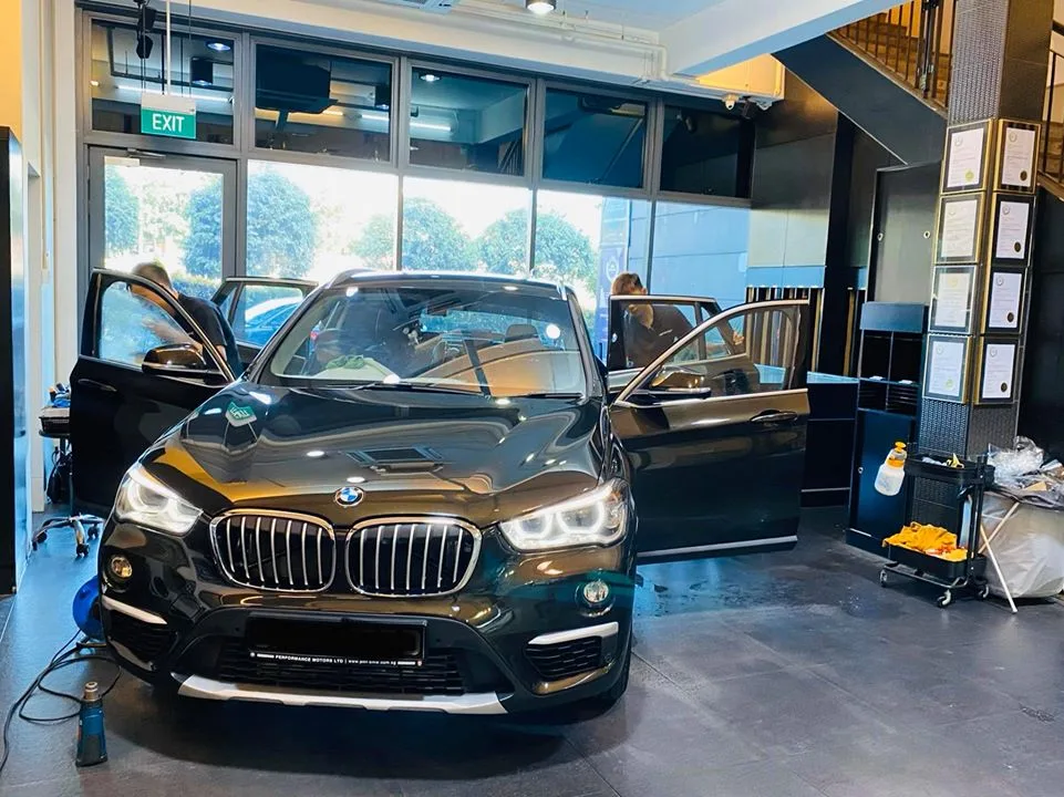 Black BMW SUV front view with doors open before window tinting at Infratint Singapore