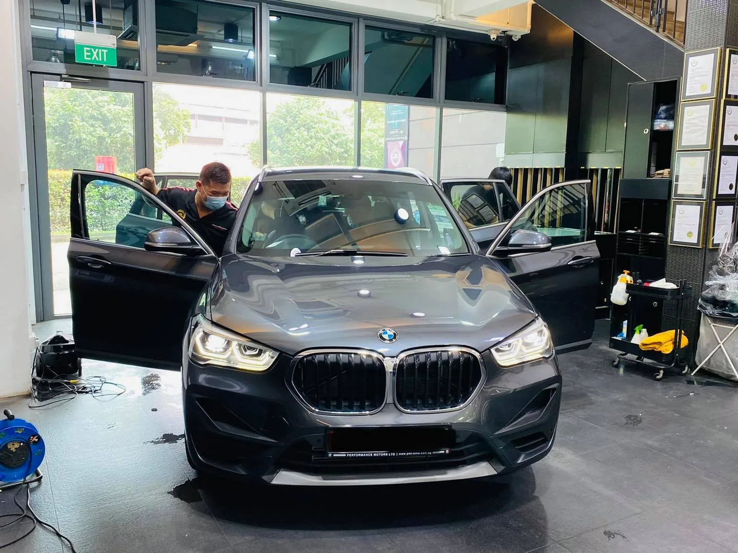 Grey BMW SUV being tinted with door open at Infratint Singapore