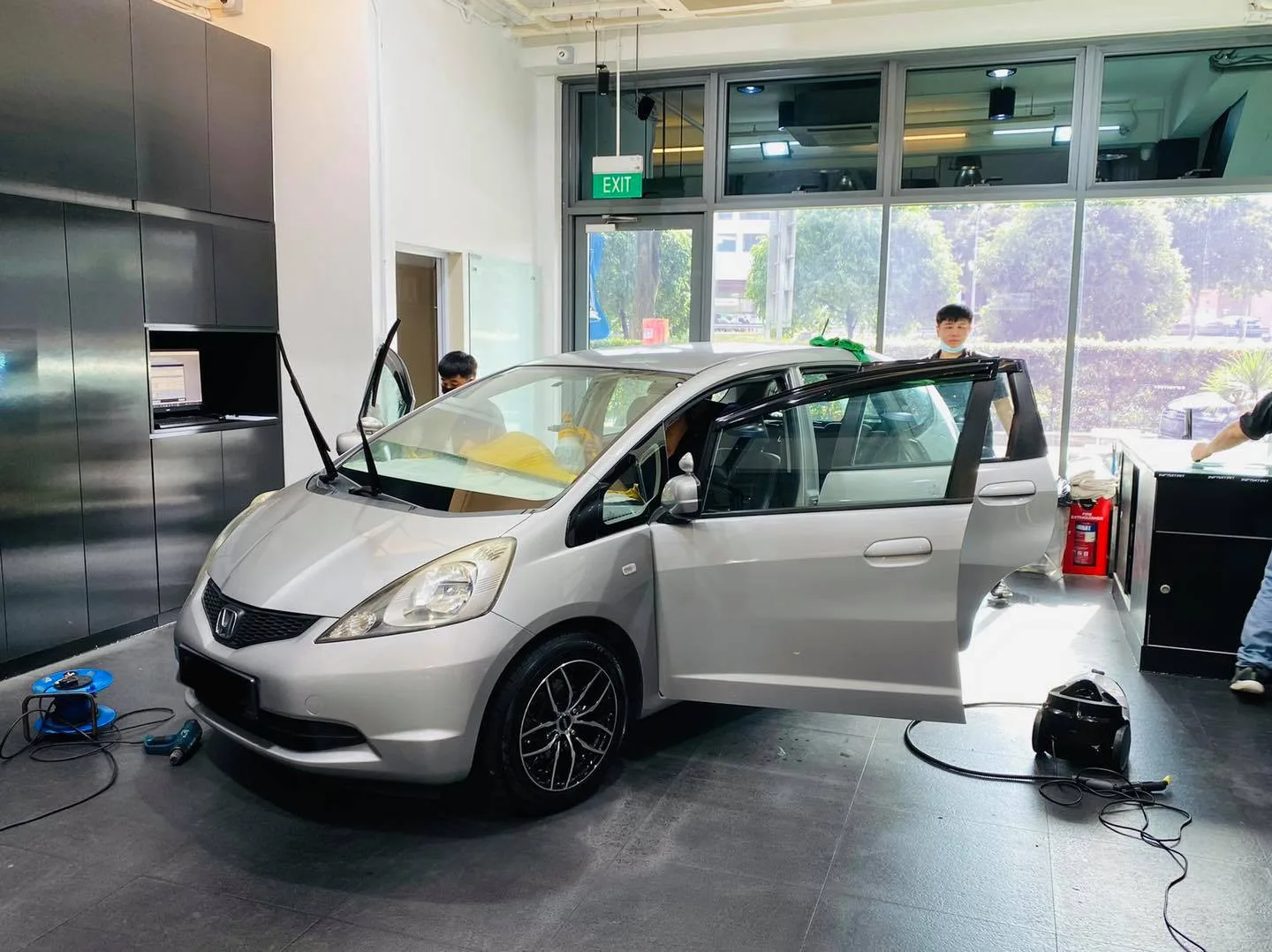 Silver Honda hatchback during window film installation at Infratint Singapore
