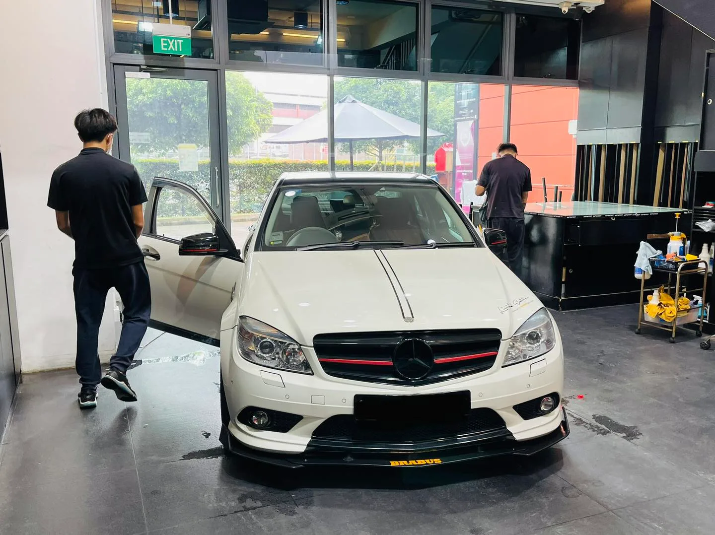 White Mercedes-Benz C-Class with door open during window tinting at Infratint Singapore