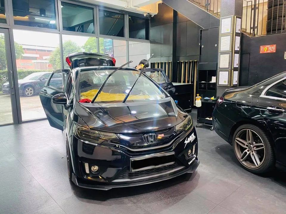 Black Honda Jazz hatchback with body kit at Infratint Singapore