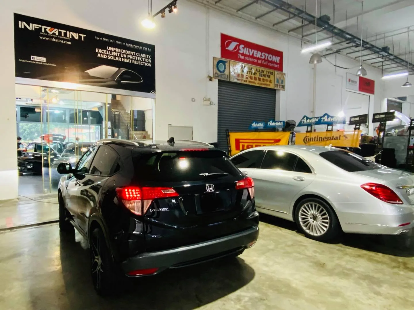 Black Honda Vezel SUV and silver Mercedes-Benz S-Class at Infratint Singapore