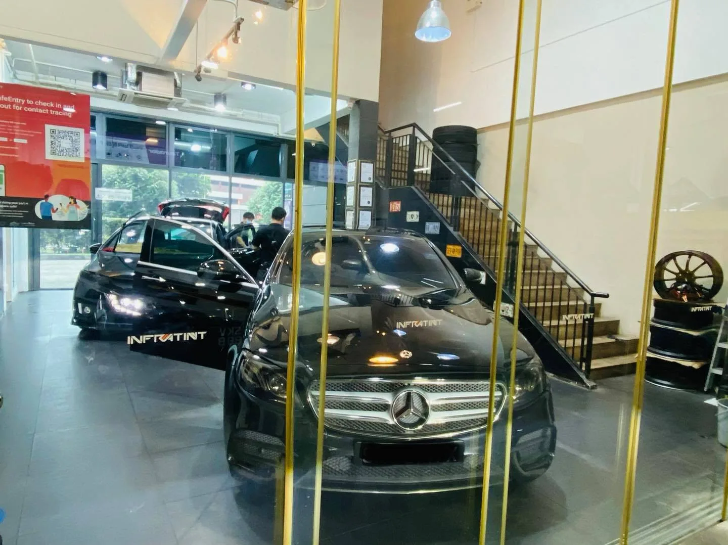 Black Mercedes-Benz E-Class sedan viewed through glass at Infratint Singapore