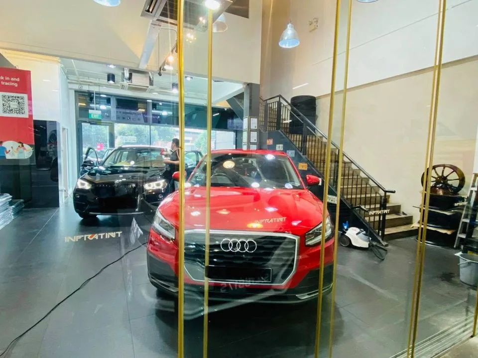 Red Audi Q2 SUV and black BMW SUV at Infratint Singapore