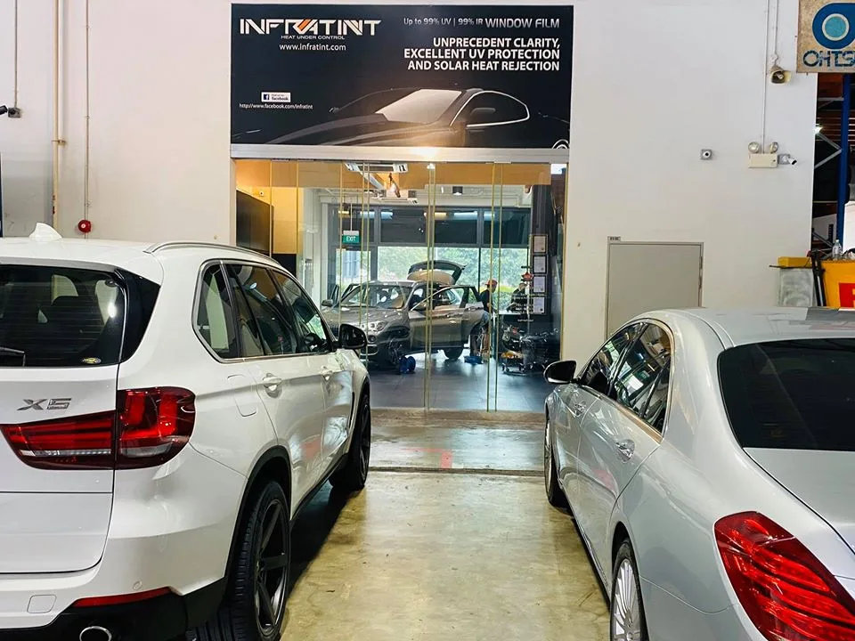 White BMW X5 and silver Mercedes-Benz sedan parked at Infratint Singapore