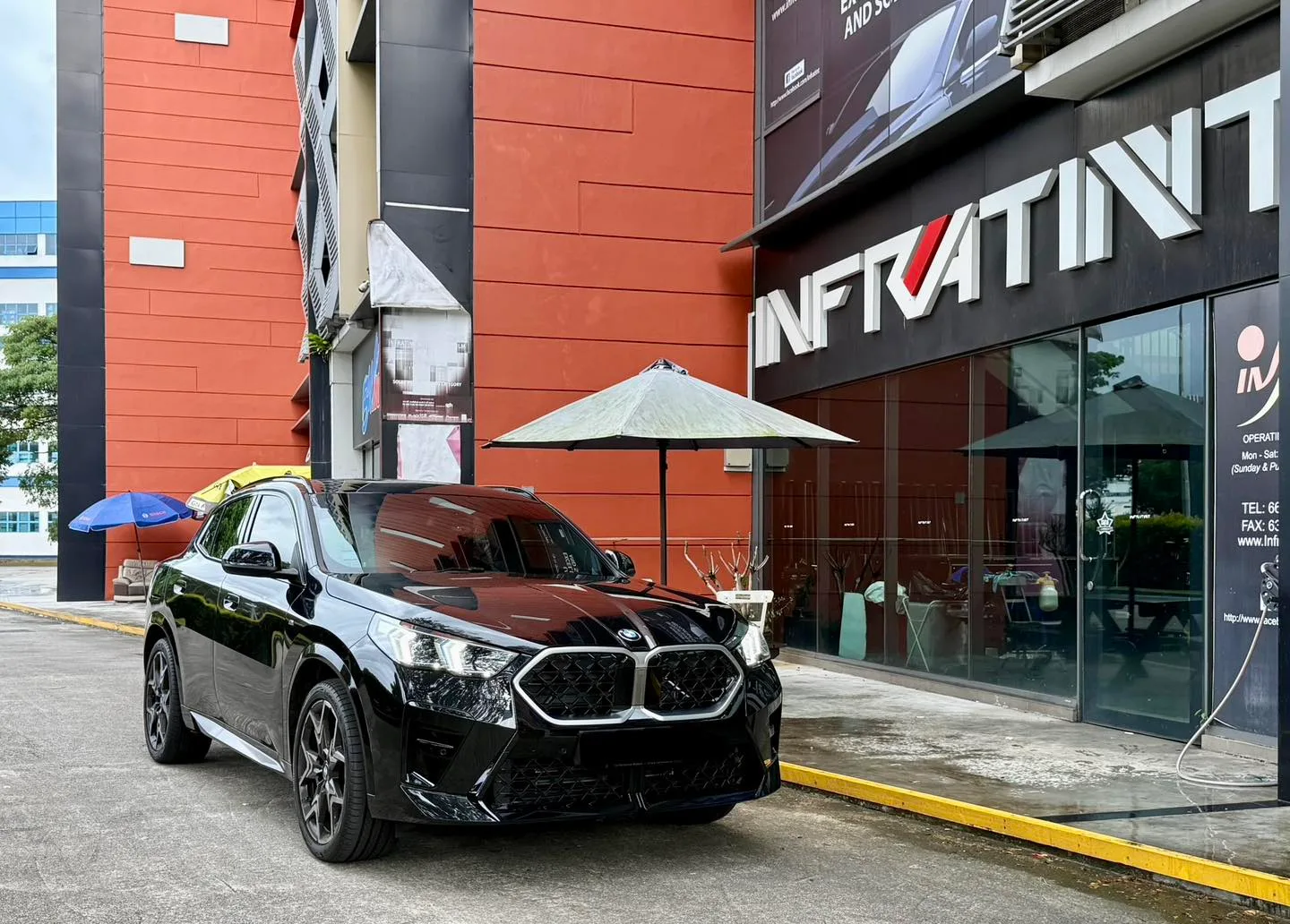 Tinted black BMW X2 front three-quarter view outside Infratint Singapore