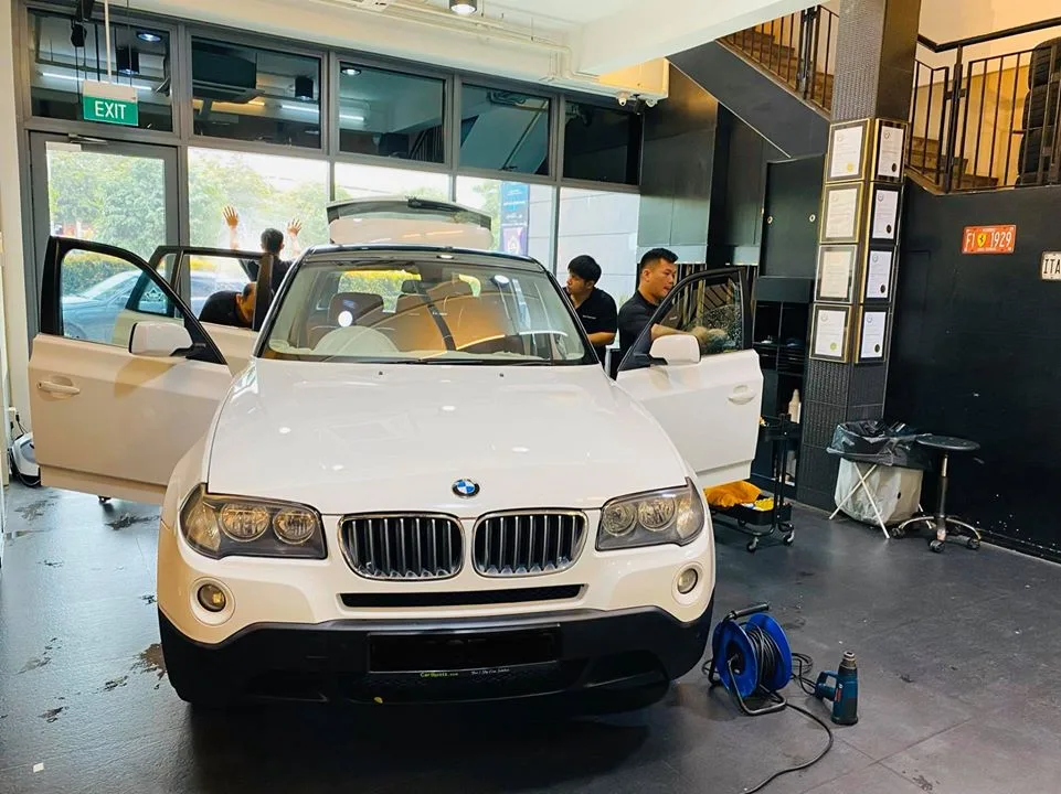 White BMW X3 SUV opened up for window tinting at Infratint Singapore