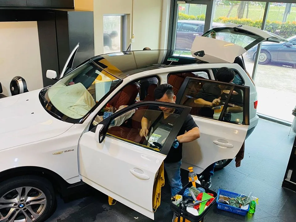 White BMW X3 with red interior having door tint installed at Infratint Singapore