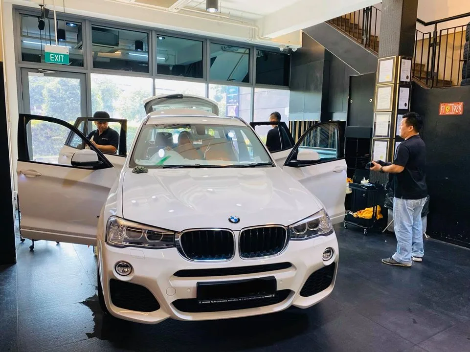 White BMW X3 SUV with doors open before window tinting at Infratint Singapore