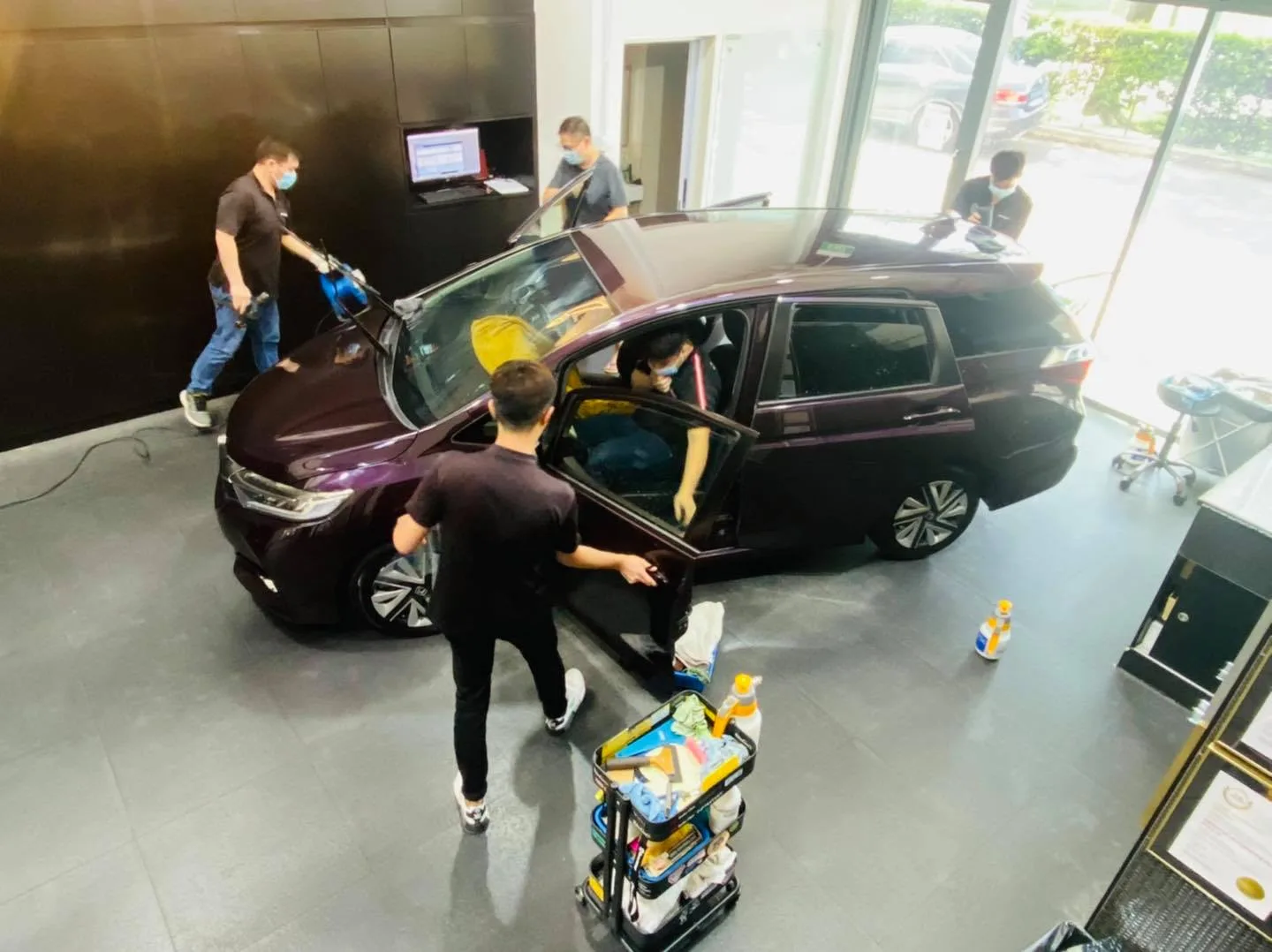 Team tinting a purple Honda MPV viewed from above at Infratint Singapore