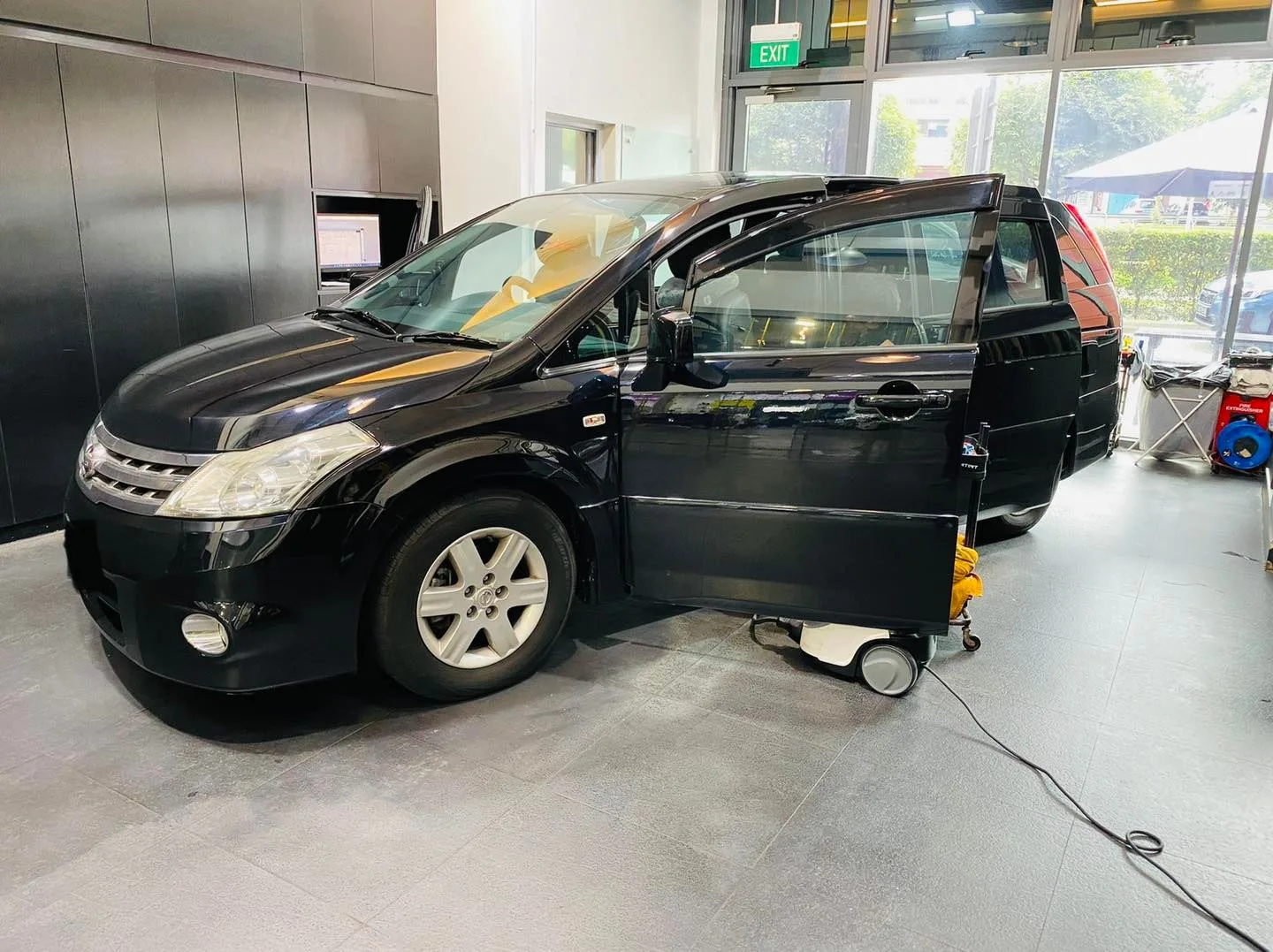 Black Nissan MPV being window tinted at Infratint Singapore