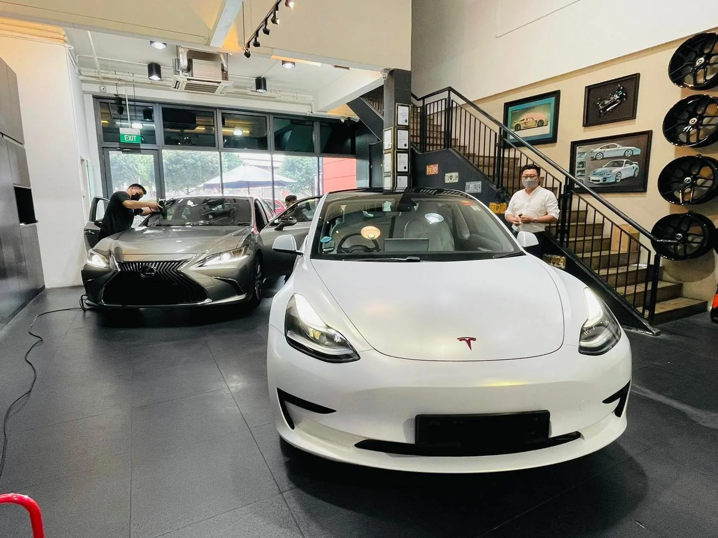 White Tesla Model 3 and grey Lexus sedan in the Infratint Singapore showroom