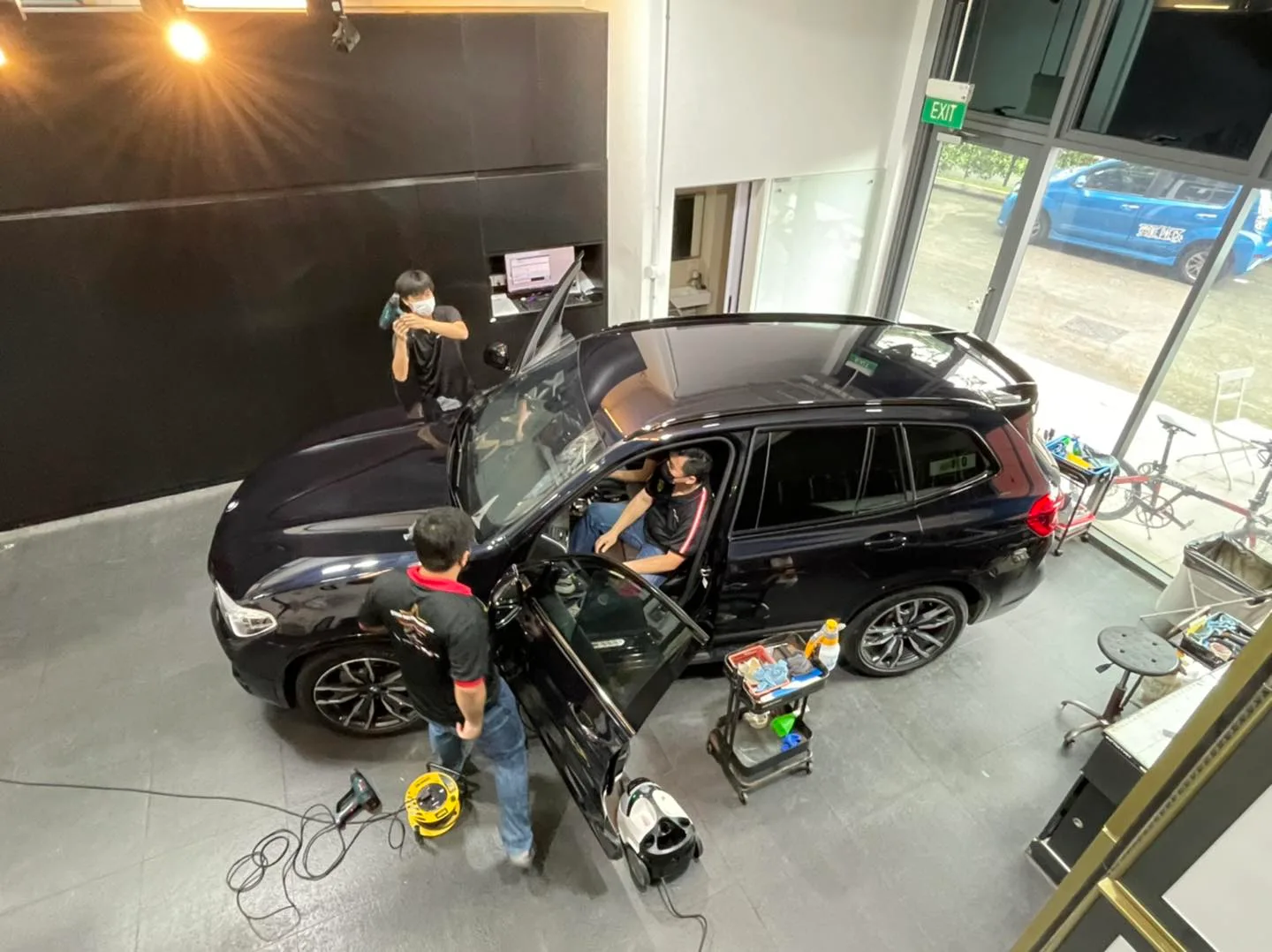 Overhead view of a black BMW SUV being tinted at Infratint Singapore