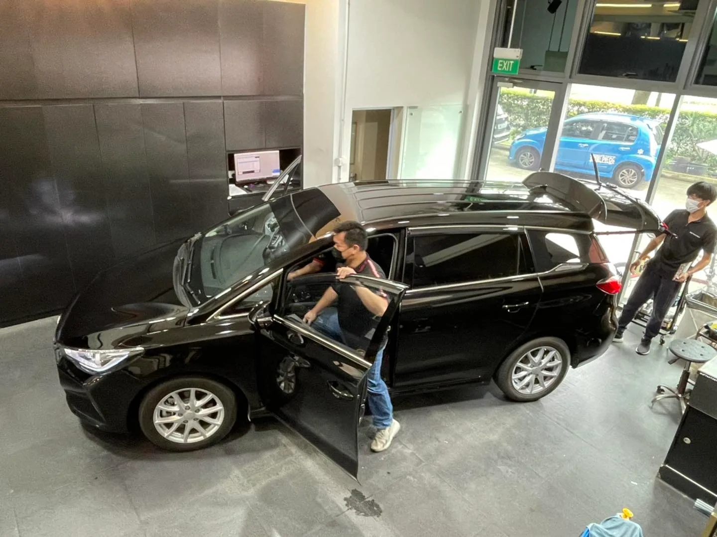 Black wagon with raised tailgate during window tinting at Infratint Singapore