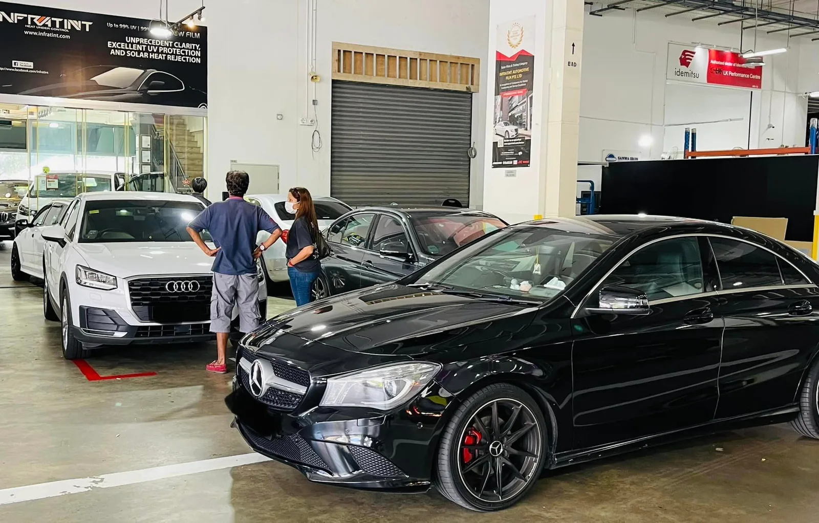 Black Mercedes-Benz CLA and white Audi Q2 in the Infratint Singapore install bay