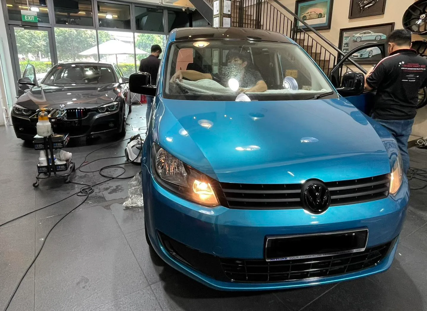 Blue Volkswagen Caddy and grey BMW F30 at Infratint Singapore for window film