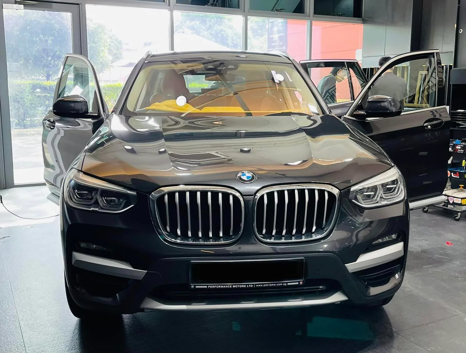 Grey BMW X3 front view prepared for window tinting at Infratint Singapore