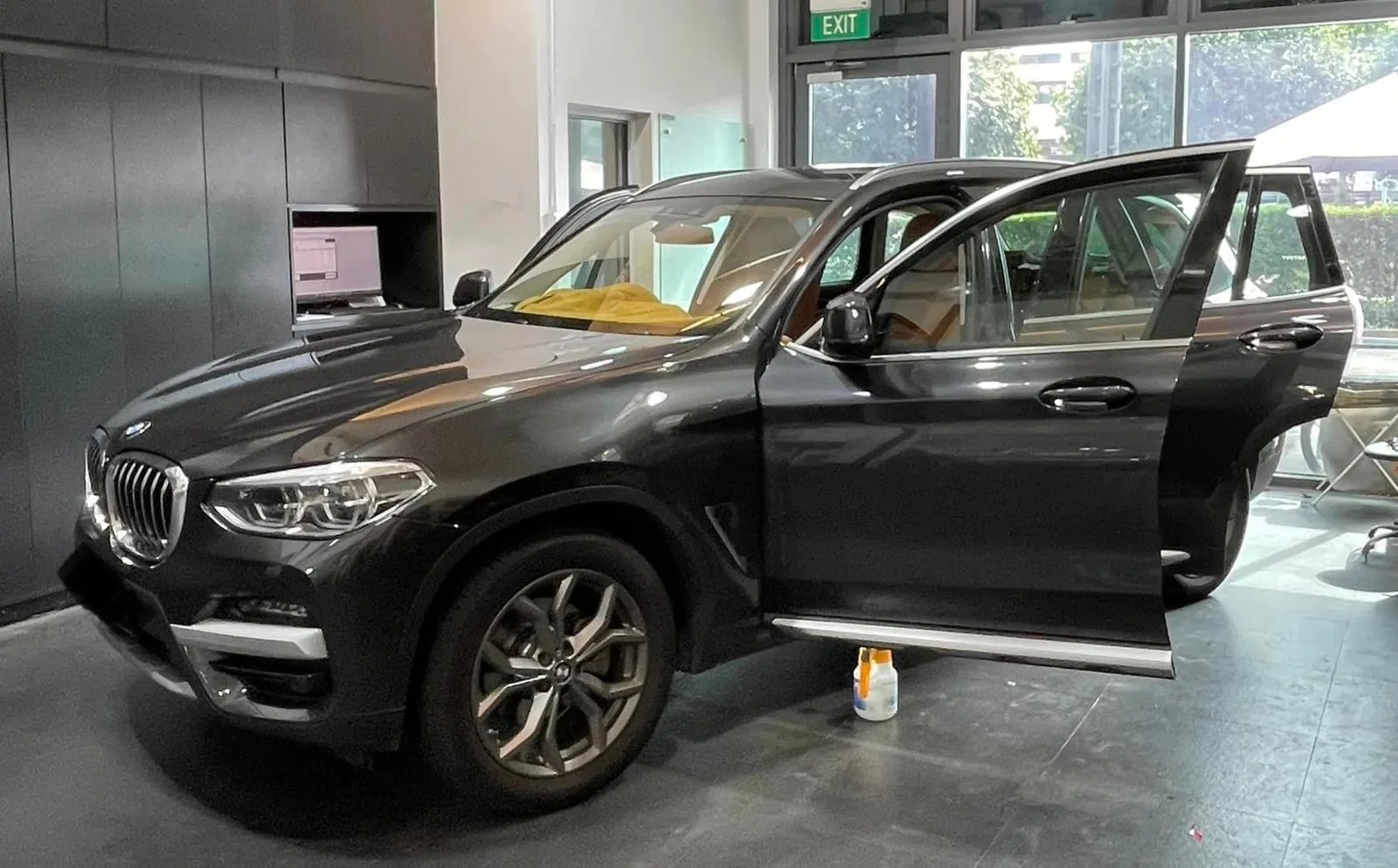 Grey BMW X3 with open doors and tan interior at Infratint Singapore window tinting