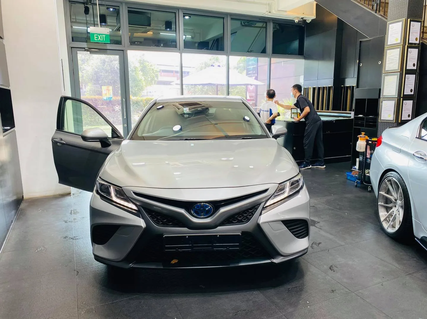 Silver Toyota Camry sedan in the install bay at Infratint Singapore for window film