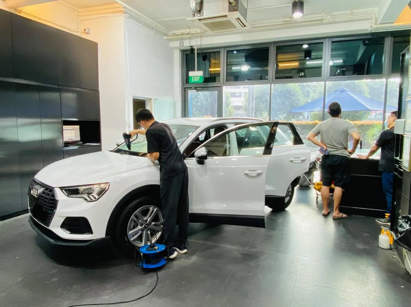White Audi Q3 SUV being tinted from the side at Infratint Singapore