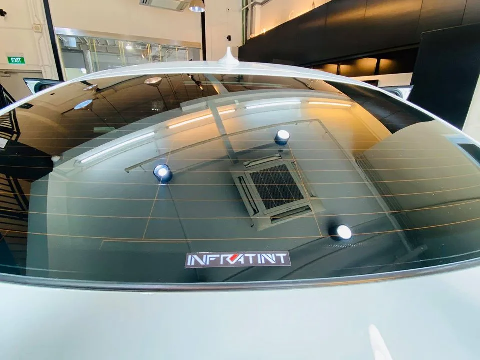 Infratint logo on the tinted rear window of a white BMW X4 at Infratint Singapore