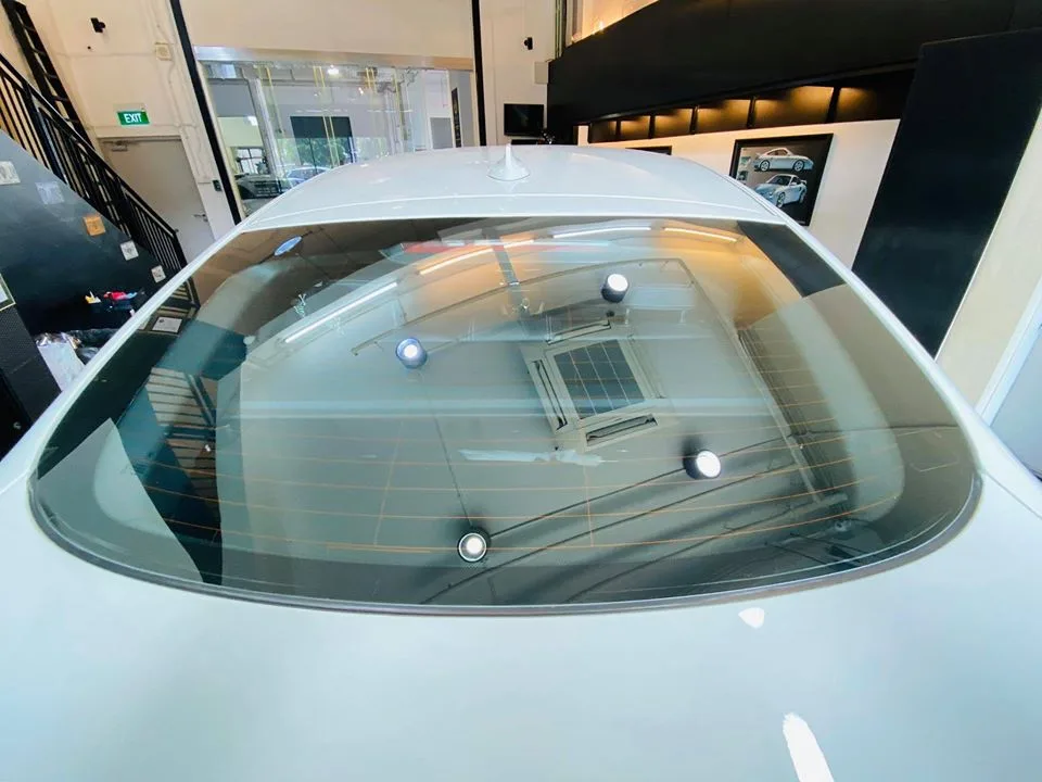 Close-up of the tinted rear windscreen on a white BMW X4 at Infratint Singapore