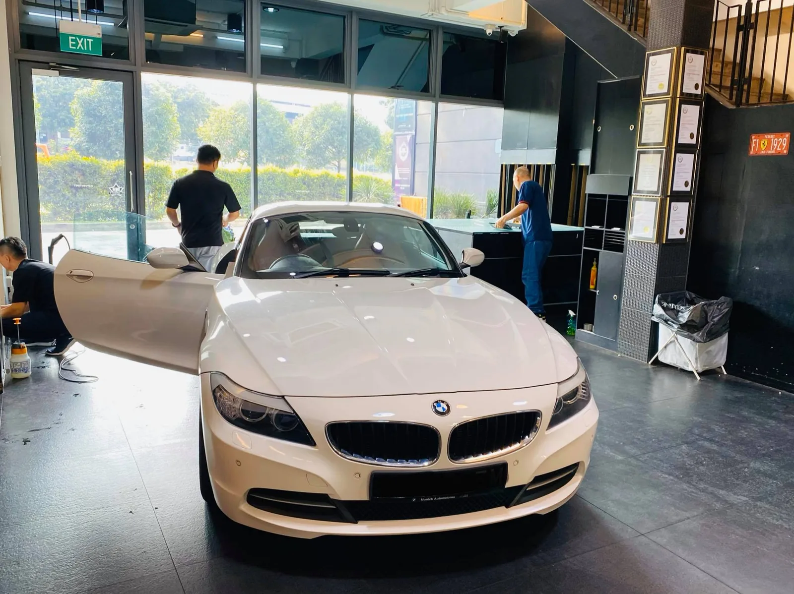 White BMW roadster with door open being prepared for window tinting at Infratint Singapore