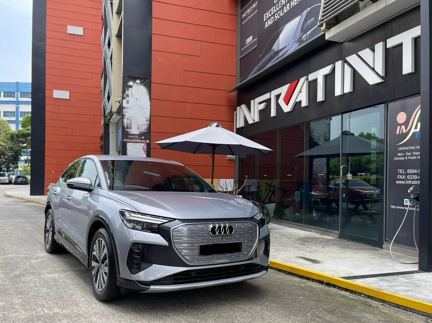 Silver Audi Q4 Sportback e-tron front three-quarter view outside Infratint Singapore