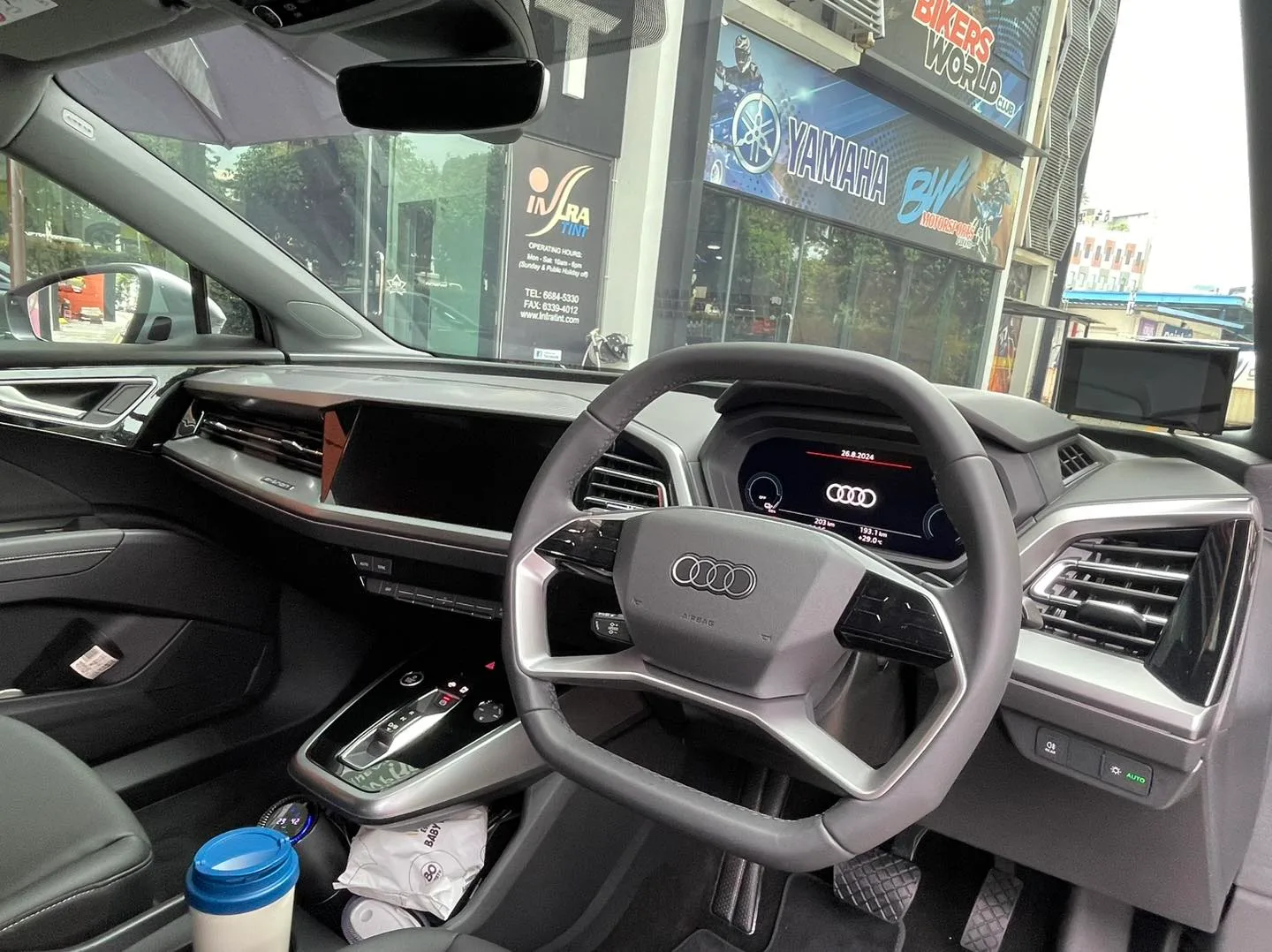 Audi Q4 Sportback e-tron interior virtual cockpit and steering wheel seen through tinted glass at Infratint Singapore