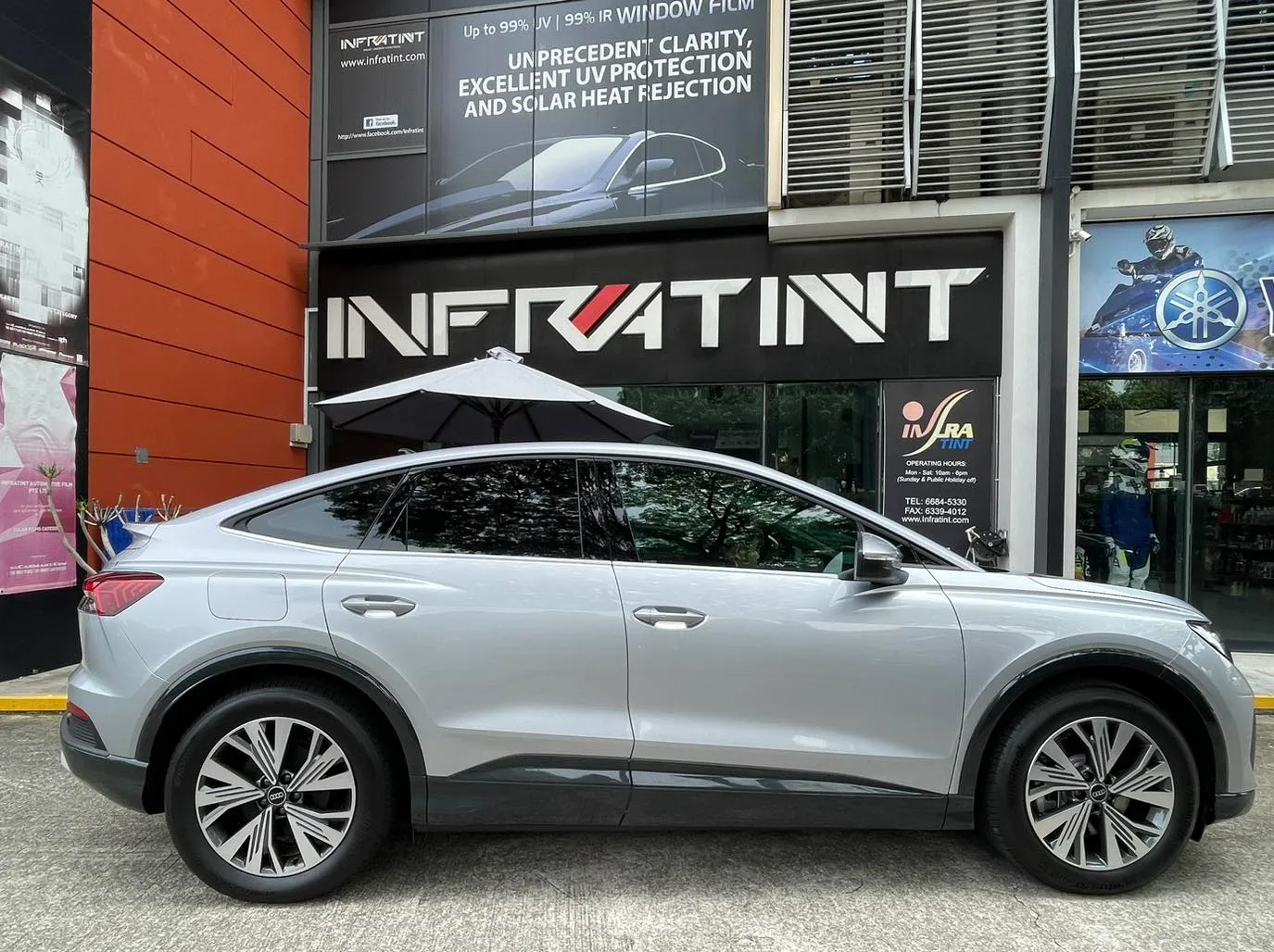 Silver Audi Q4 Sportback e-tron side profile with tinted windows at Infratint Singapore