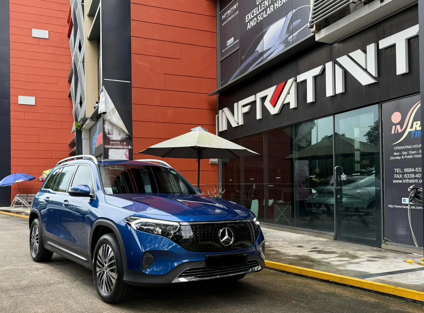 Blue Mercedes-Benz EQB front three-quarter view outside Infratint Singapore