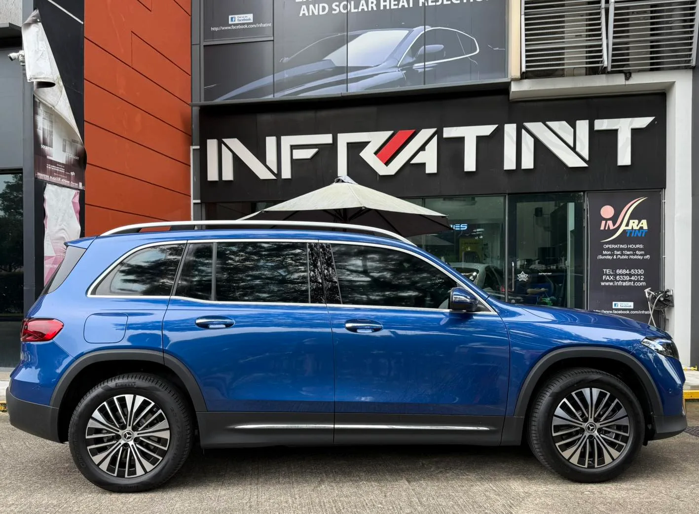 Blue Mercedes-Benz EQB side profile with tinted windows at Infratint Singapore