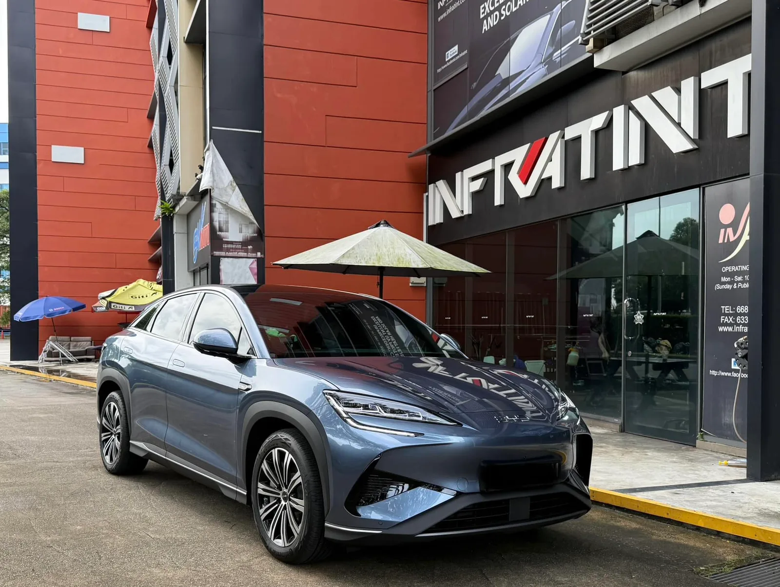 Tinted blue-grey BYD Sealion 7 front three-quarter view outside Infratint Singapore