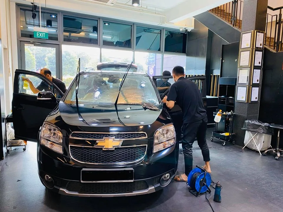 Black Chevrolet Orlando MPV during window tinting at Infratint Singapore