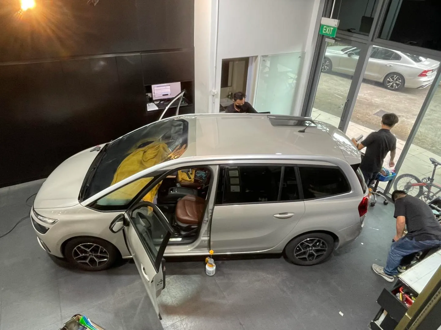 Overhead view of a beige Citroen Grand C4 MPV being tinted at Infratint Singapore