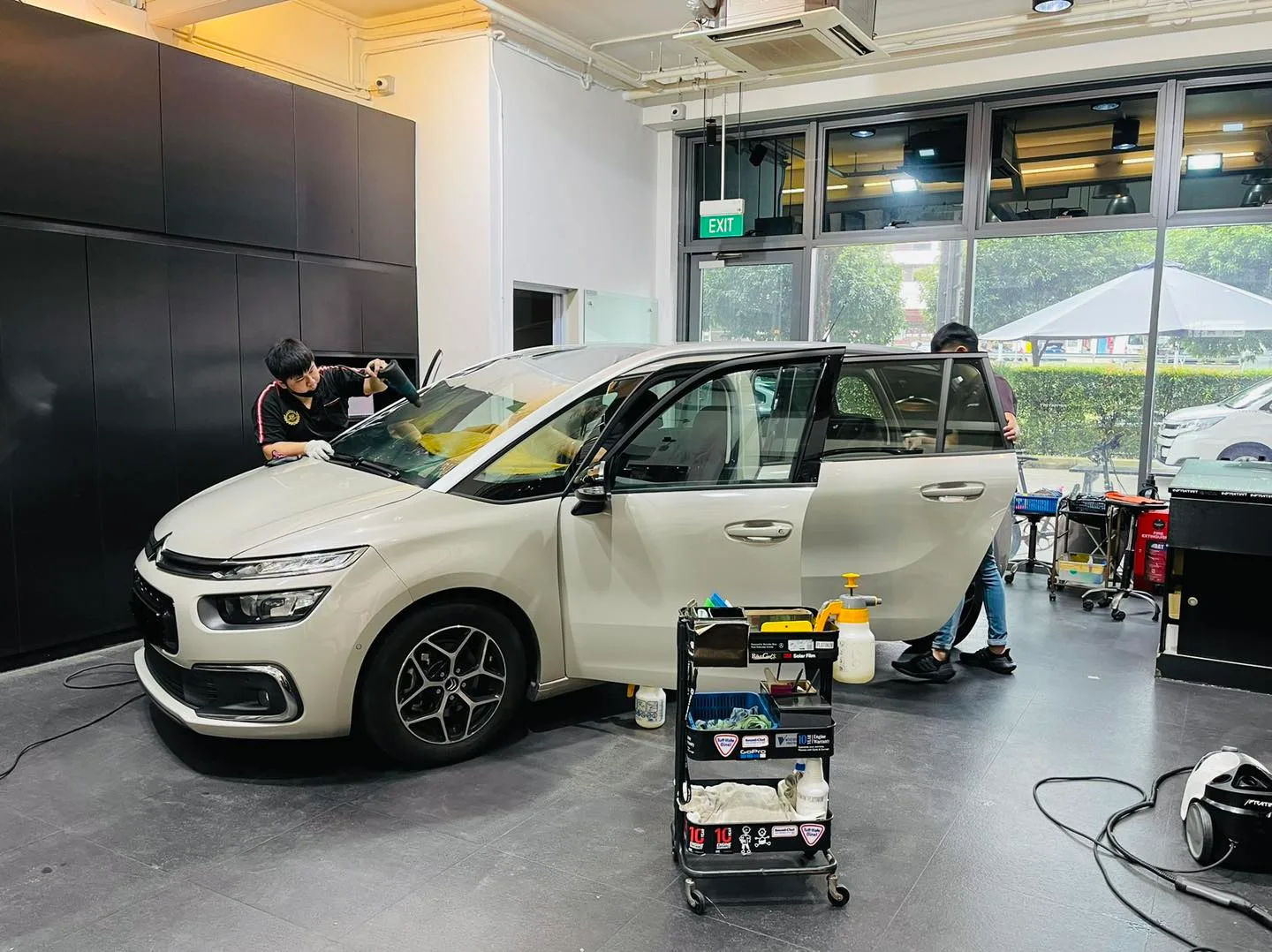 Side view of a beige Citroen C4 MPV during tinting at Infratint Singapore