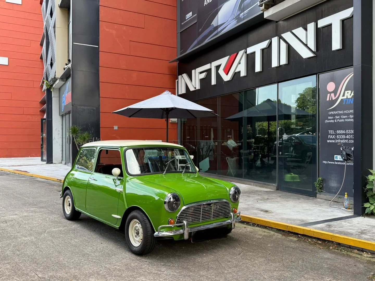 Green classic MINI Cooper front three-quarter view with tinted glass at Infratint Singapore