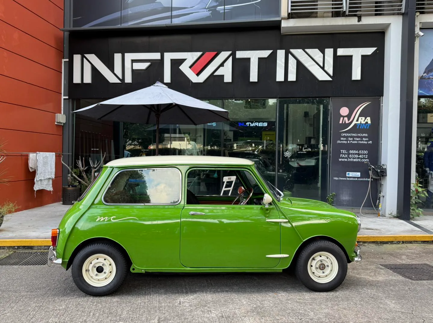 Green classic MINI Cooper side profile with tinted glass outside Infratint Singapore